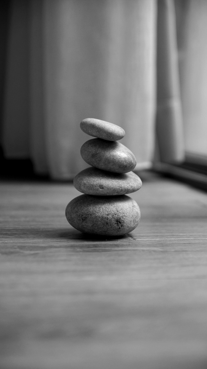 our-mission Black and white image of a stack of smooth stones evoking balance and tranquility.